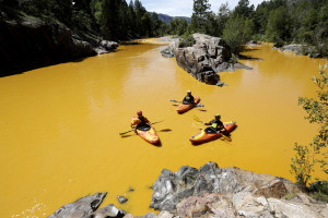 People kayak in the Animas River near Durango, Colo., Thursday, Aug. 6, 2015, in water colored from a mine waste spill. The U.S. Environmental Protection Agency said that a cleanup team was working with heavy equipment Wednesday to secure an entrance to the Gold King Mine. Workers instead released an estimated 1 million gallons of mine waste into Cement Creek, which flows into the Animas River. (Jerry McBride/The Durango Herald via AP) MANDATORY CREDIT